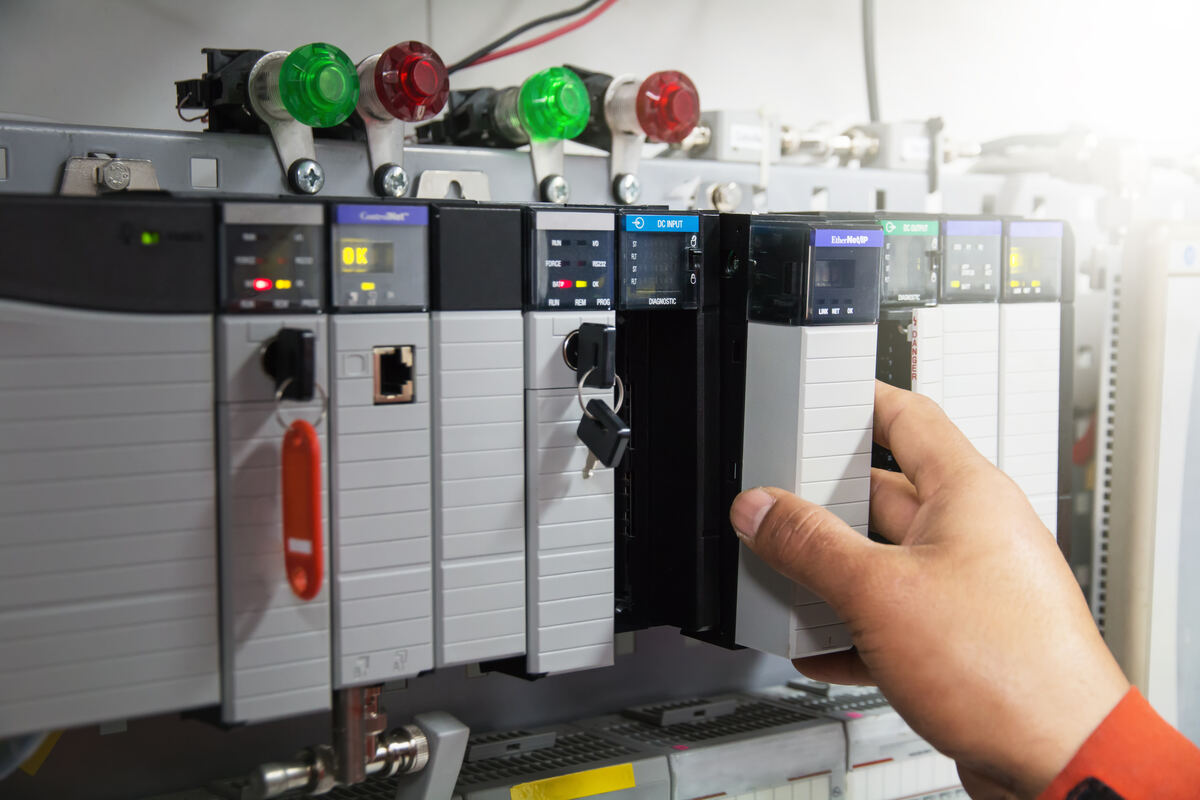 Engineer working on a PLC rack